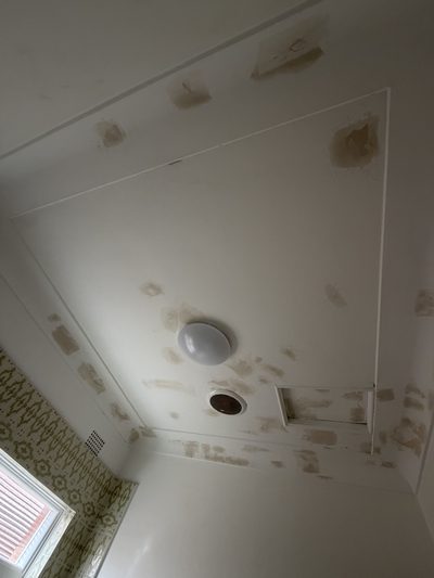 Ceiling with heavy water staining before restoration