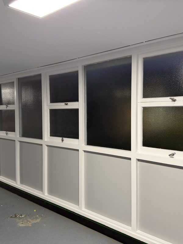 Commercial corridor with window joinery finished in white