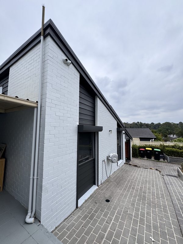 Exterior painted brickwork with charcoal fascia and trim