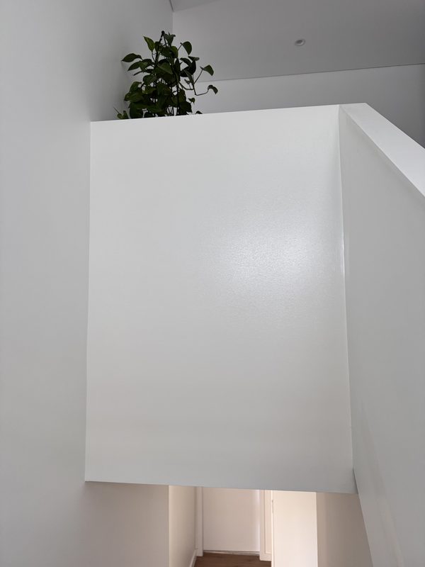 Double-height stairwell void finished in seamless white